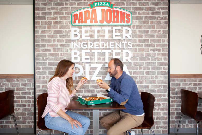 A couple eating Papa Johns pizza