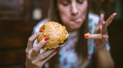 A girl eating a tasty burger