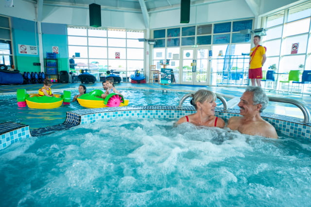 Couple sat in indoor swimming pool