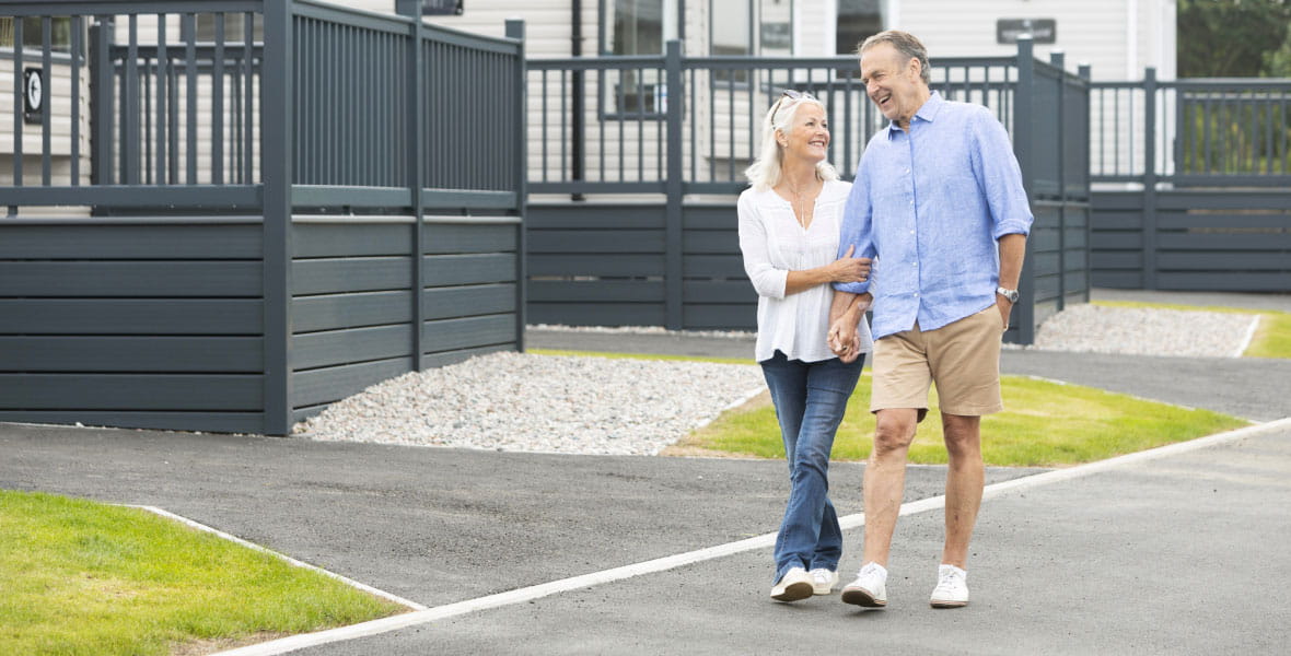 Older couple walking down pavement