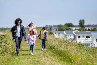 Family walking next to caravans