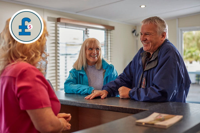 A couple speaking with the owner experience team on a Parkdean holiday park