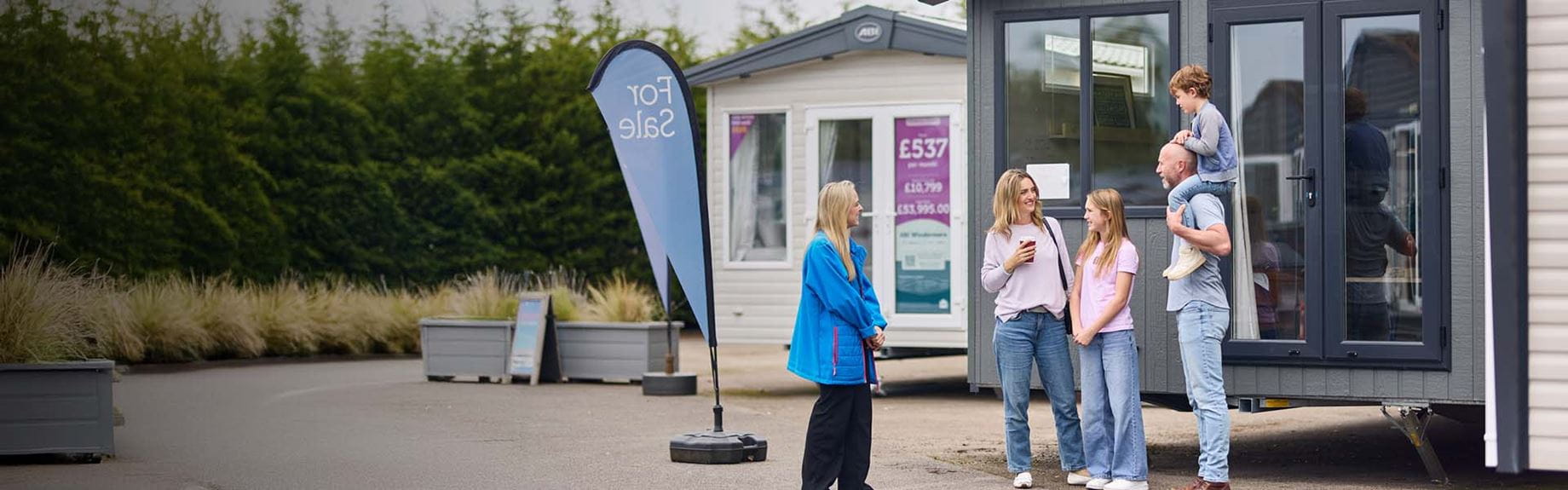 A family looking at caravans for sale on a Parkdean Resorts holiday park