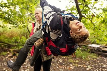 Child on swing in woods