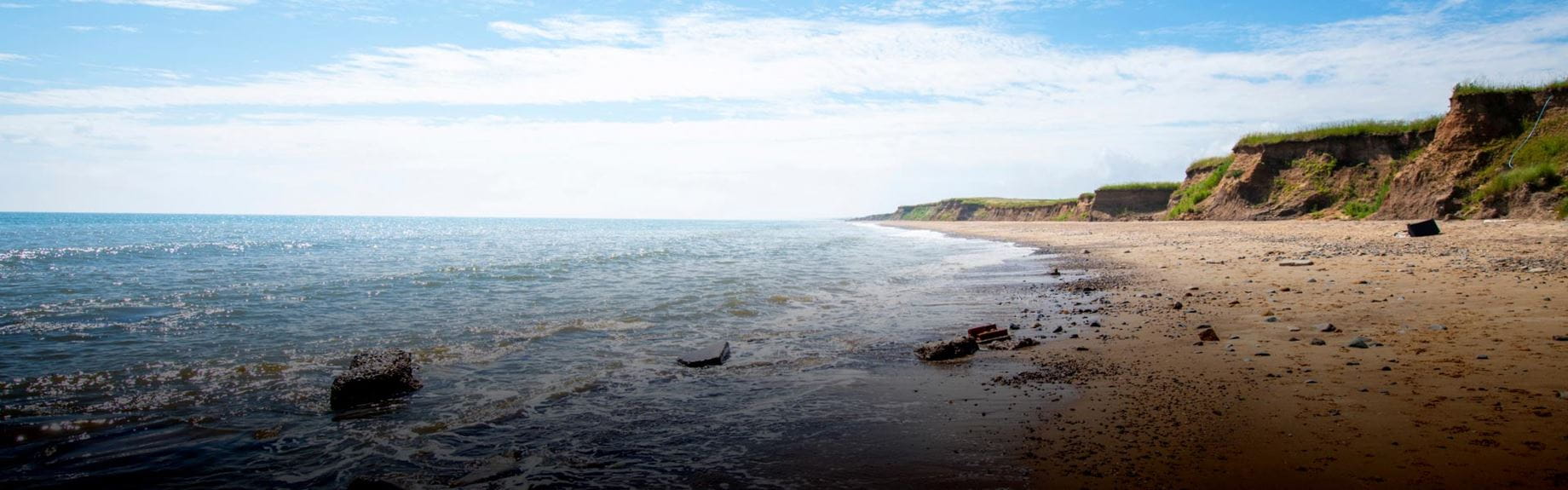 a picturesque sandy beach with cliffs