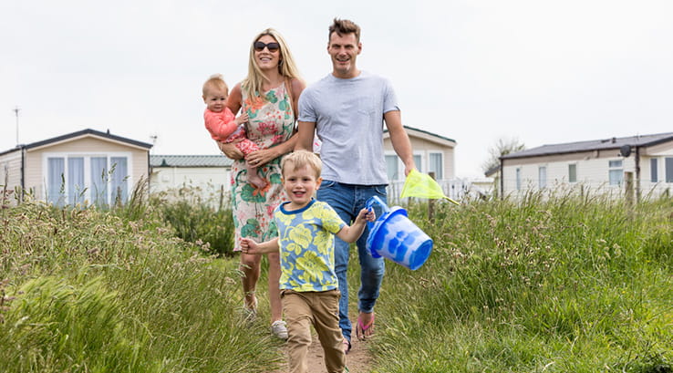 A family running down to the beach from Barmston Beach Holiday Park