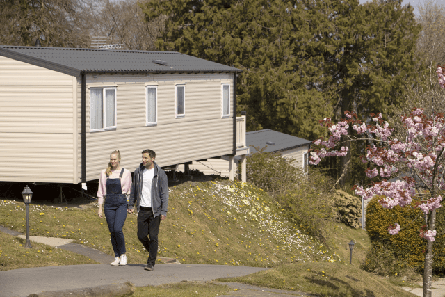 Couple walking outside Bideford Bay park home