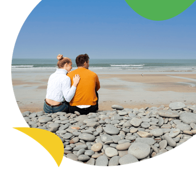 couple sat on Westward Ho! beach