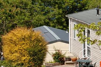 Park Dean caravan accommodation set amongst greenery and flowers