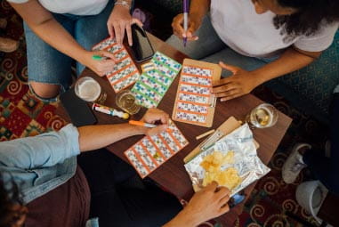 three people around a table playing bingo
