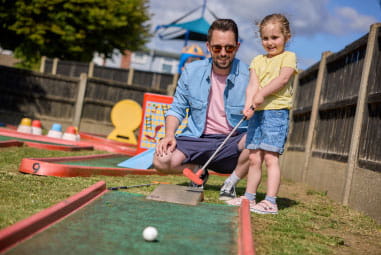 a family playing adventure golf
