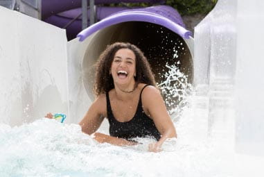 a woman riding a water slide