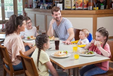 a family enjoying a meal in a restaurant
