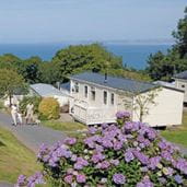 A Park Dean caravan set on a green hill