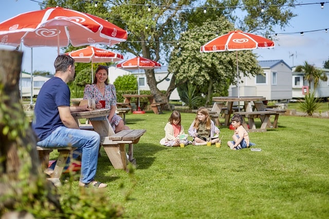 A family relaxing in the beer garden at Breydon Water Holiday Park