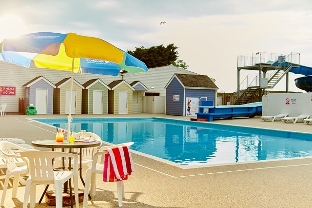 The outdoor pool and water slide at Breydon Water Holiday Park