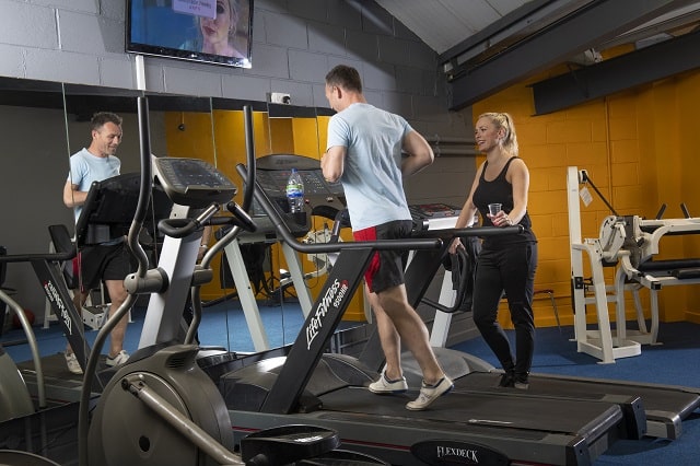 a man on a running machine in a gym