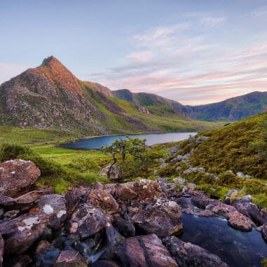 Picturesque view of mountainous, grass national park with a river running through