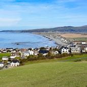 Seaside town with a row of white houses with the sea in the background
