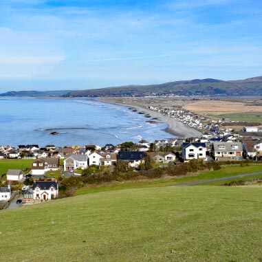 Seaside town with a row of white houses with the sea in the background