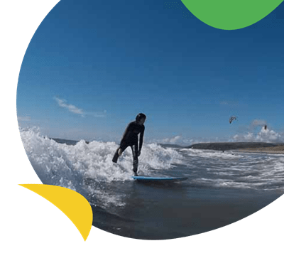 A man surfing near Brynowen Holiday Park