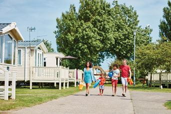 Family walking past caravans
