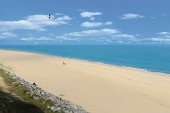 Sandy beach, blue sea and sky