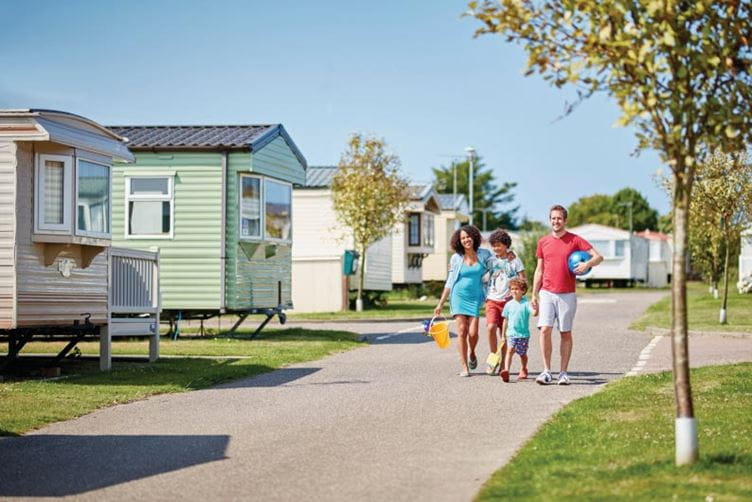 People walking through a caravan holiday park
