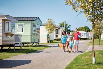 People walking through a caravan holiday park