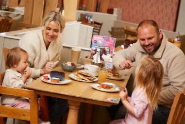 Family enjoying a meal at a restaurant table