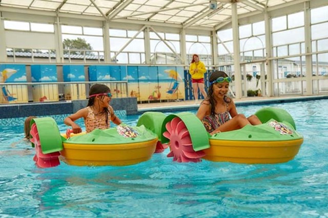 children on pedalos in the indoor pool