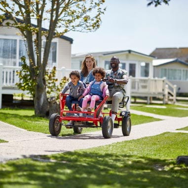 Family on a red family cart for four
