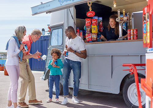 Family standing outside the food van