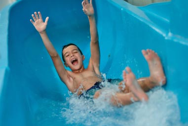 a child sliding down the water slide