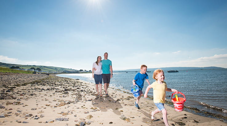 A family walking along the beach