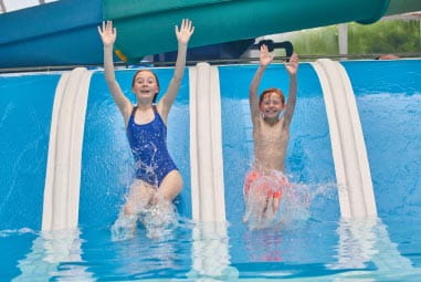 two children heading down a waterslide