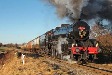 a steam train passing through fields