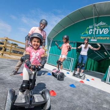 a family riding on hover boards