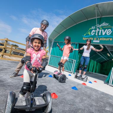 a family riding on hover boards