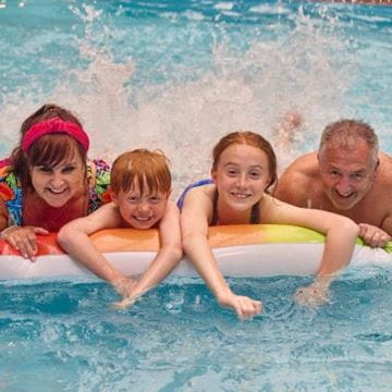 a family playing in the swimming pool