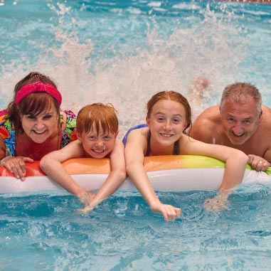a family playing in the swimming pool