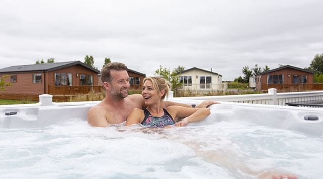 couple enjoying hot tub Cayton Bay