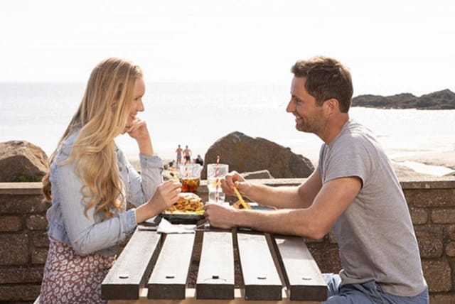 couple having a meal overlooking the sea
