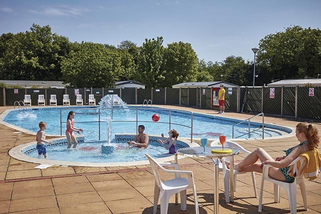 Family enjoying outdoor pool at Cherry Tree Holiday Park