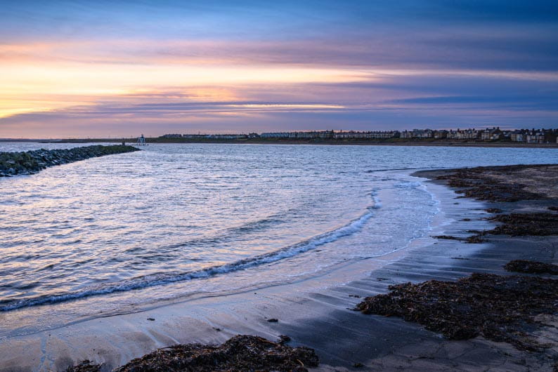 Sea with soft waves at sunset