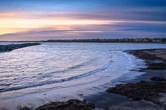 Sea with soft waves at sunset