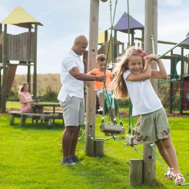 Father and children playing on an adventure playground