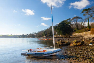 A boat on the shore of a beach