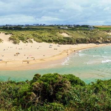 A view of a beach and sea in the summer time