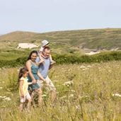 A family walking through a green field